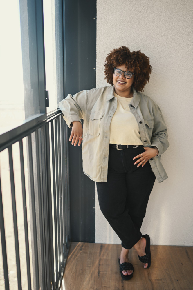 Woman with curly hair posing indoors