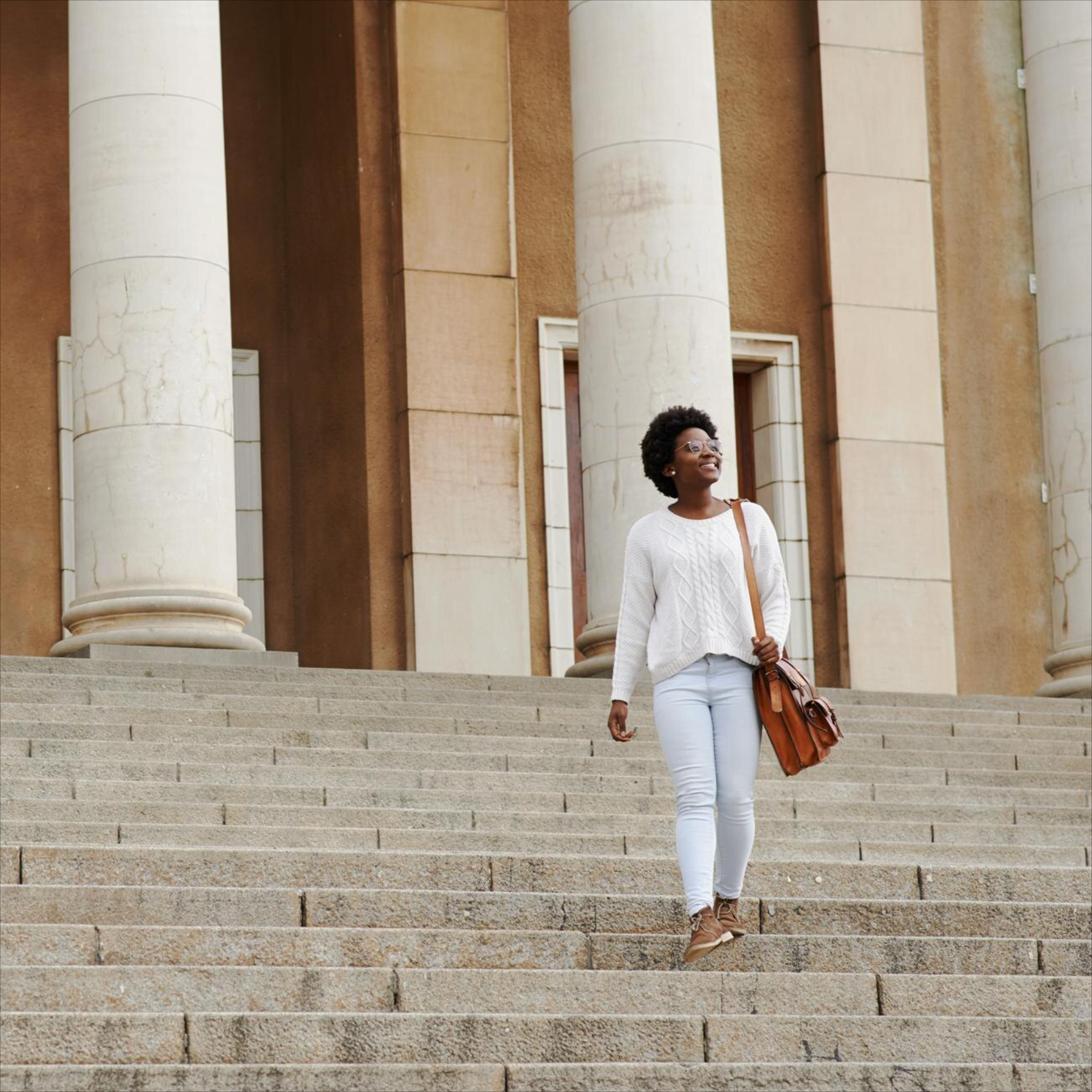 Person walking up a wide stairway in a modern building, representing continuing education for clinicians