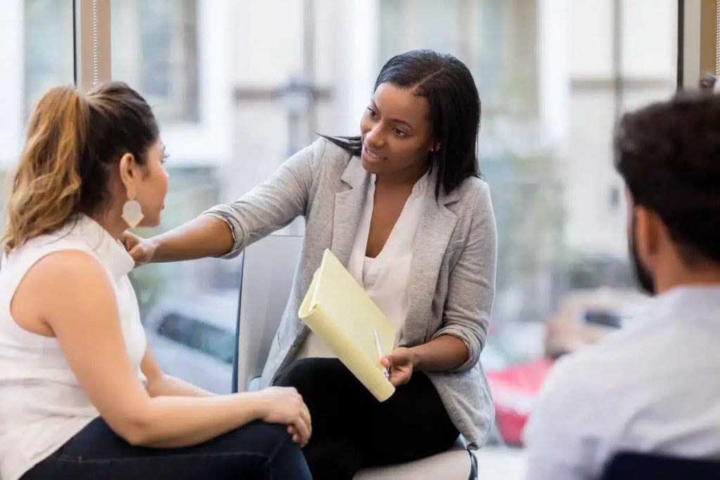Two women in conversation, one listening.