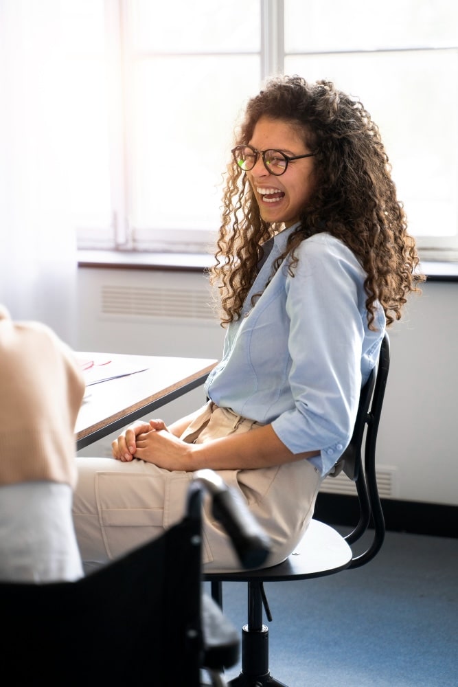 Woman laughing in a meeting room